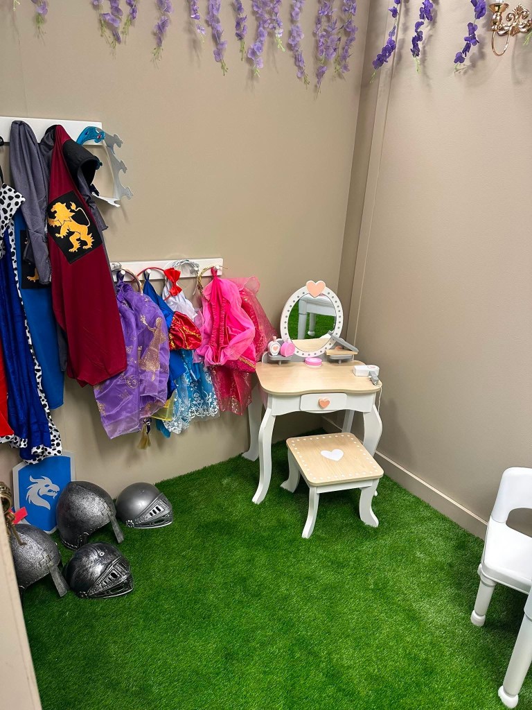 The castle dressing-up corner, with princess dresses, knight helmets and a little vanity.