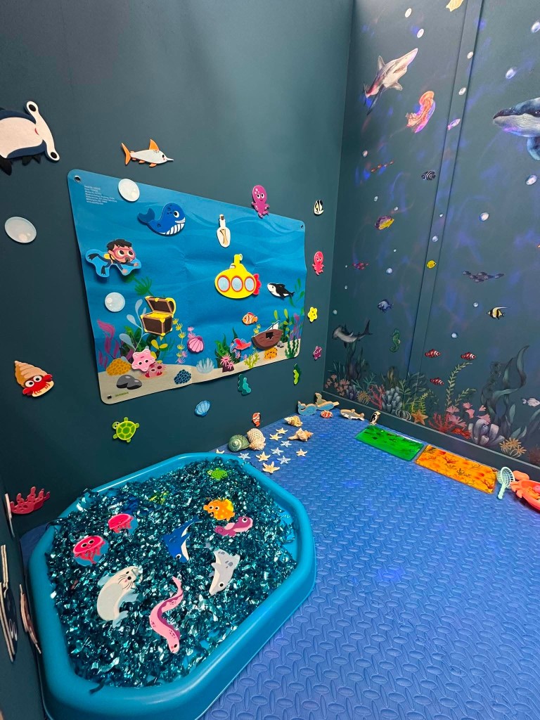 The ocean felt board, with a yellow submarine, sea creatures and a mural of fish and coral.